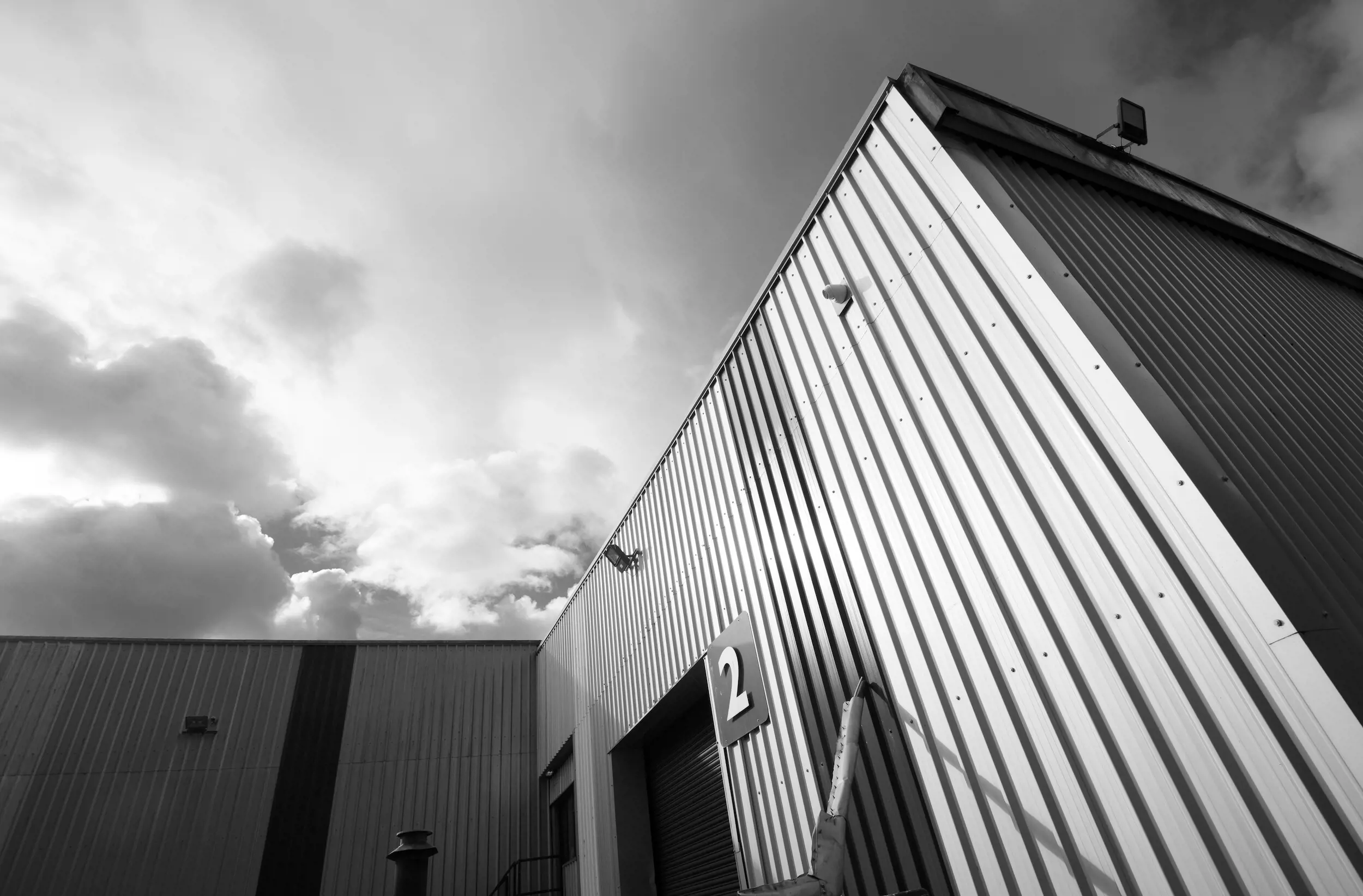 Capital Coated Steel HQ set against sky, greyscale