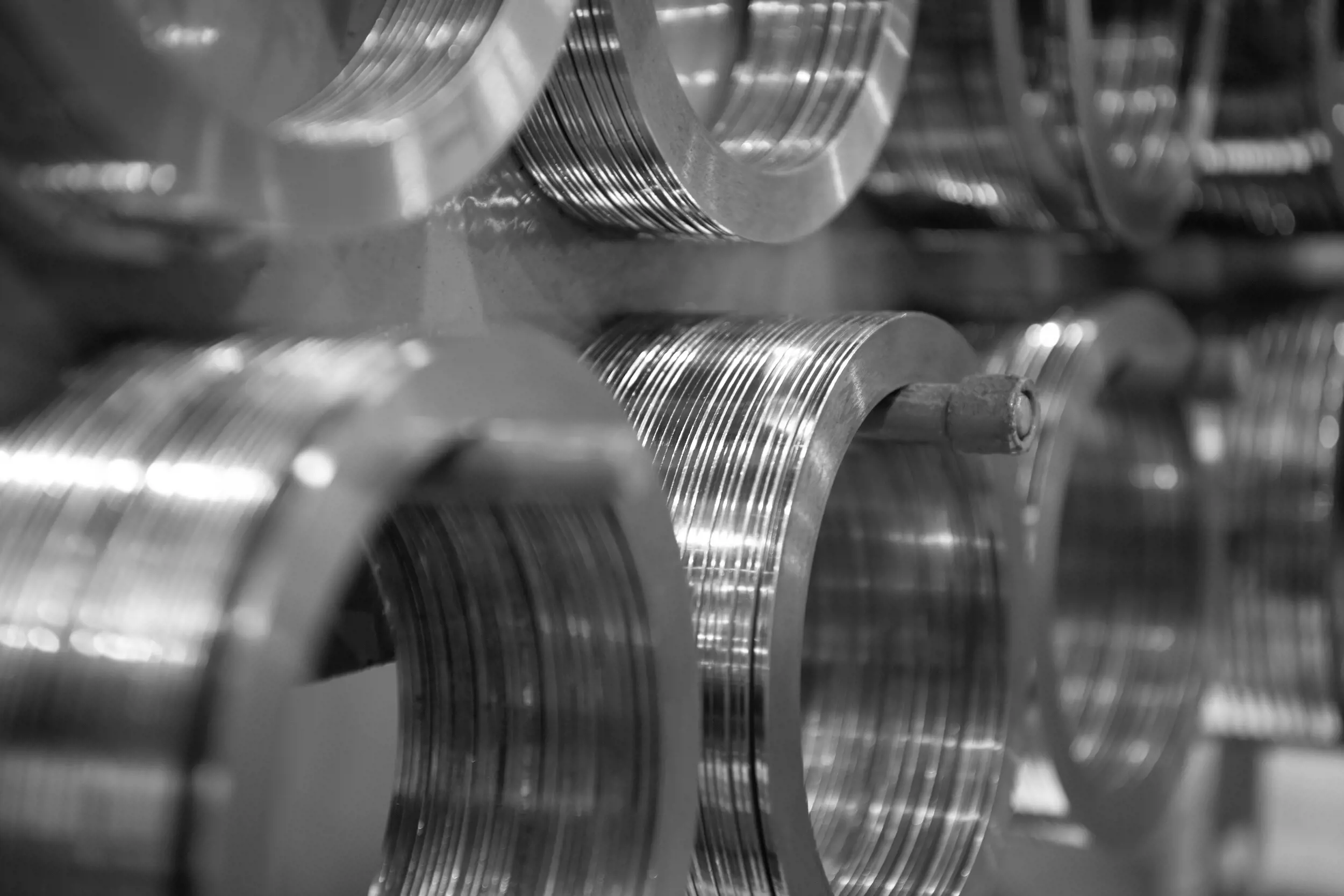 Close up of multiple smaller coils of steel, displayed on a rack