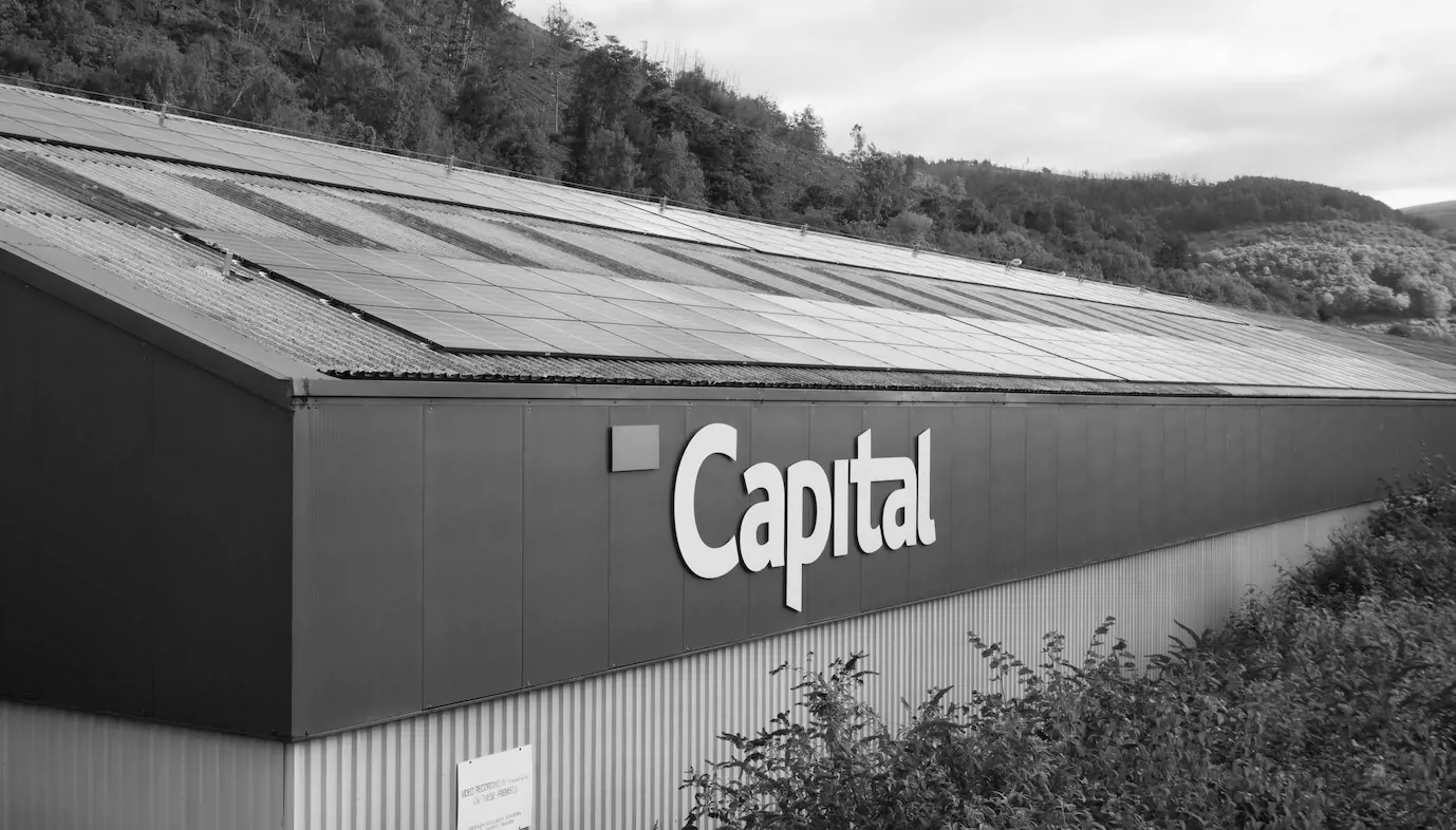 Capital Coated Steel HQ set against woodland, greyscale