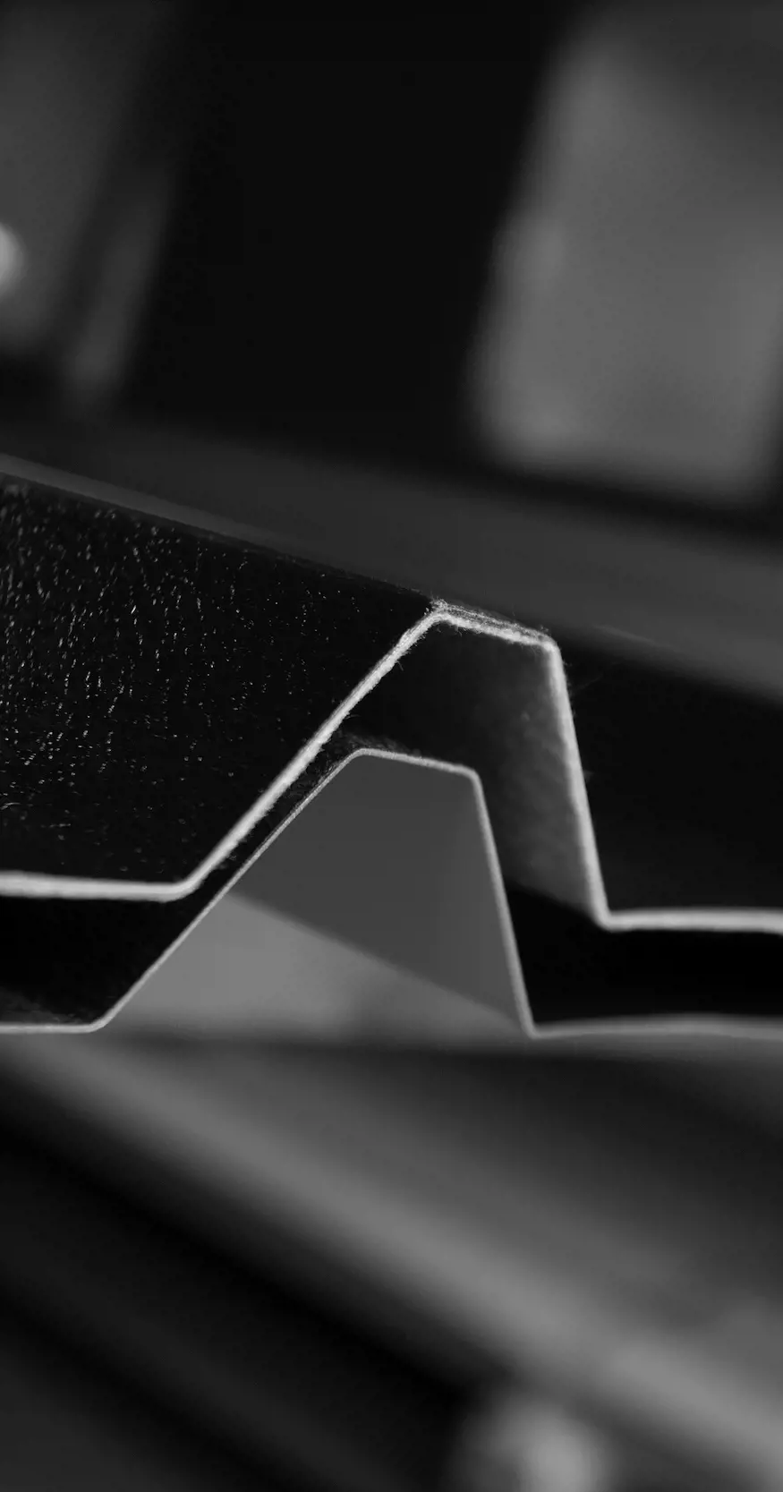 Abstract greyscale image of corrugated steel
